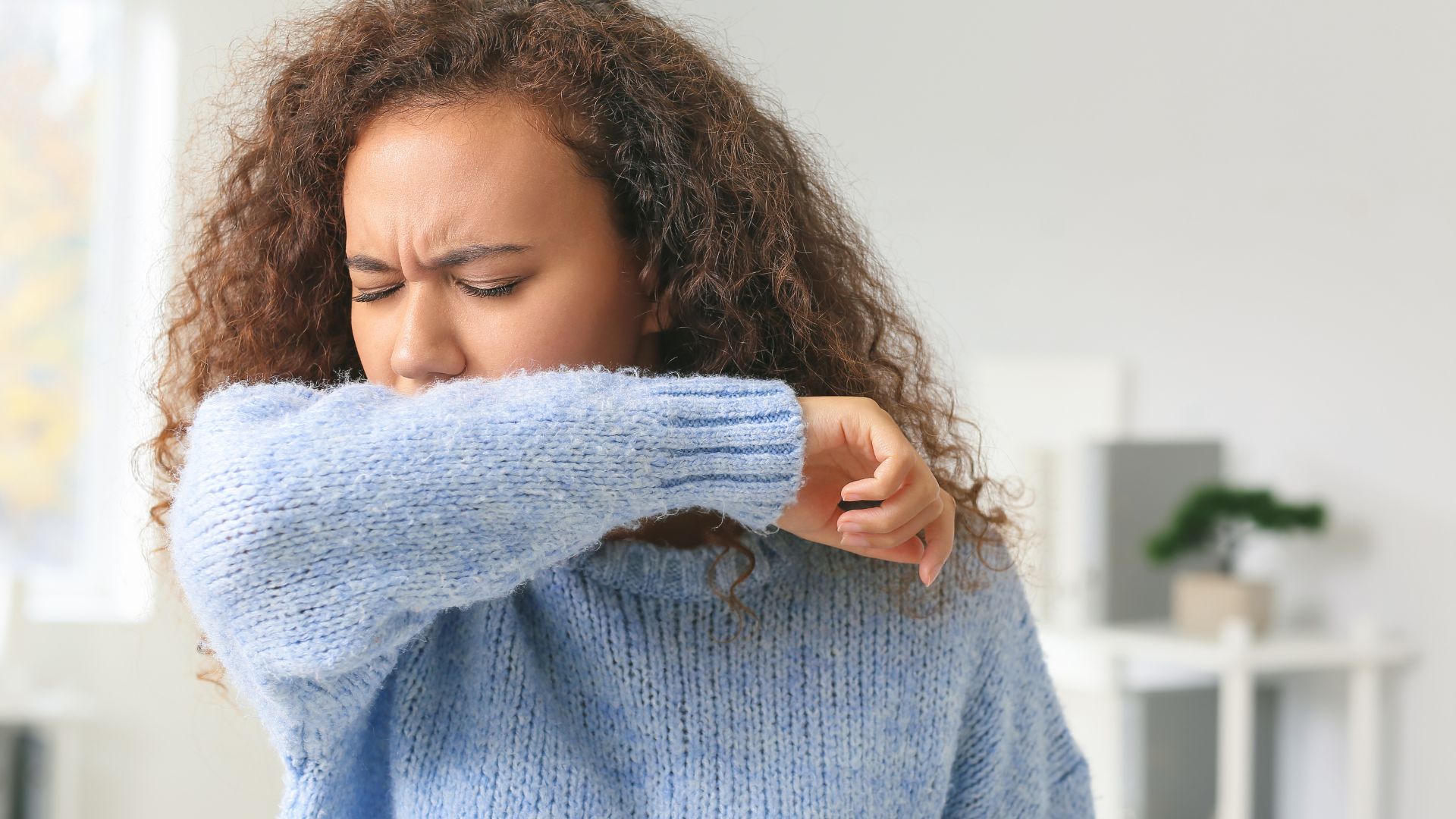Woman with flu-like symptoms, representing fever
