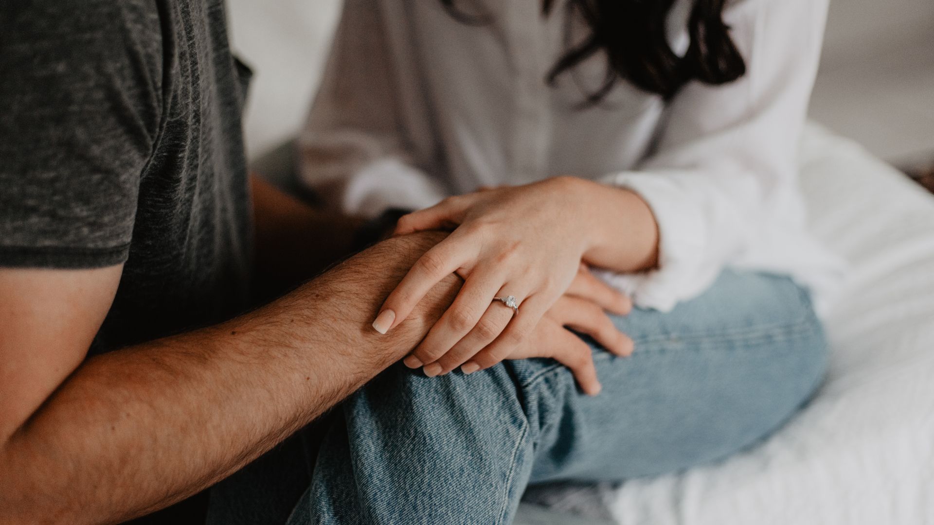 A couple sitting close together, representing deciding when to test after sex